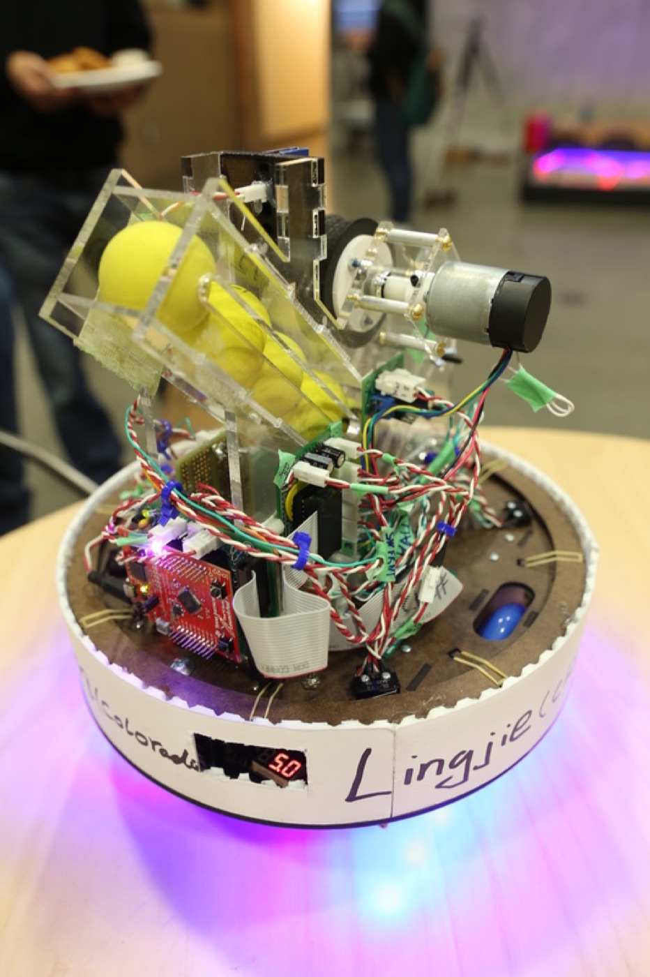 DaleBot glowing on its LED base, with Lingjie written on the rim